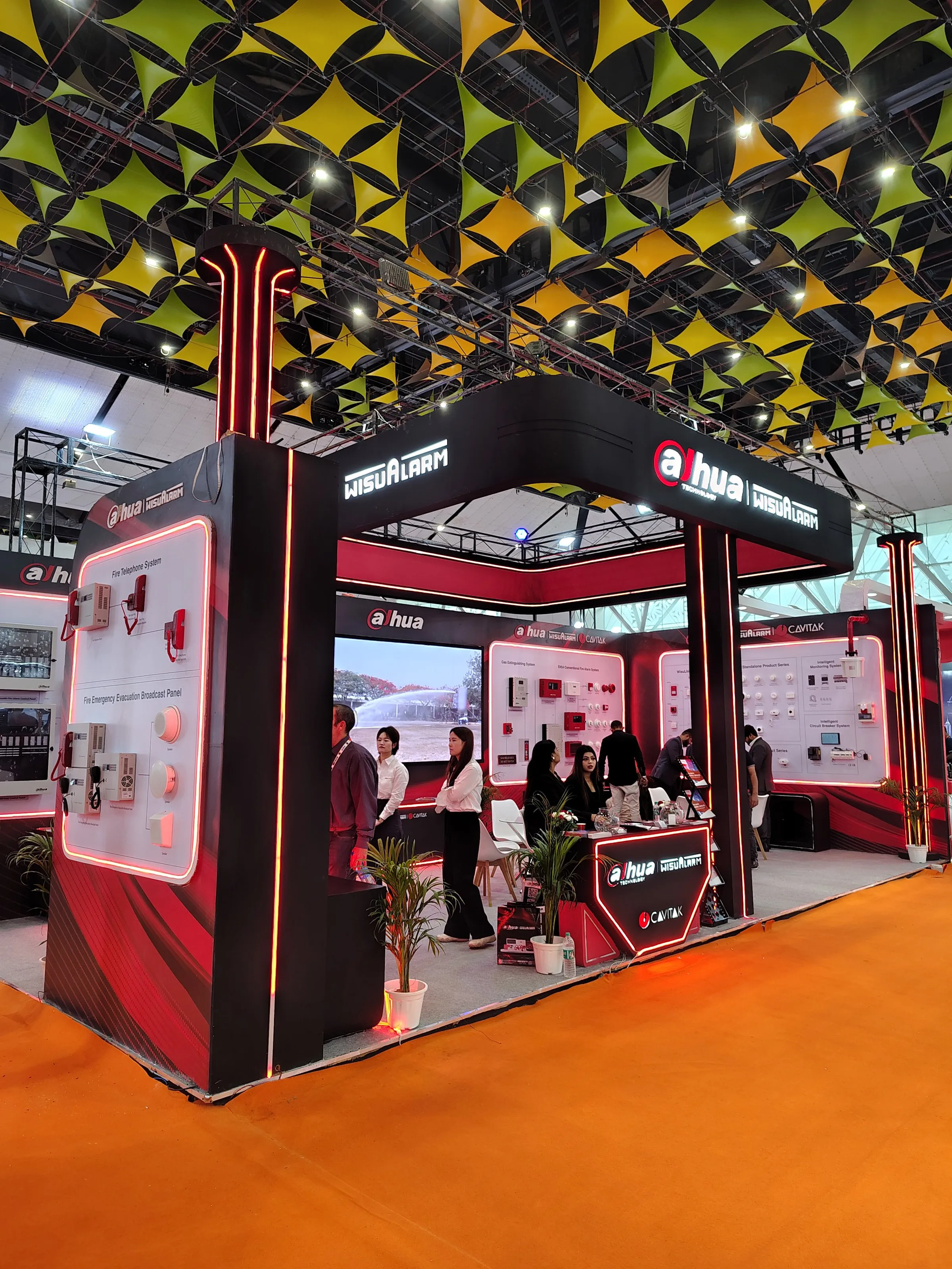Dahua booth with a black Dahua sign, red light lines and an orange floor