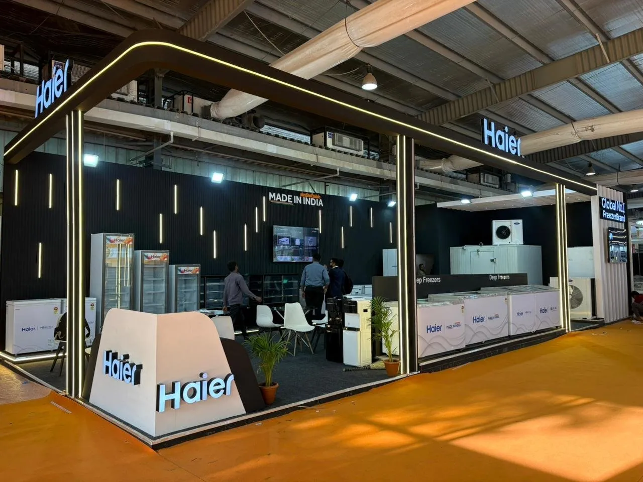 Haier booth with a dark wall and lit frame