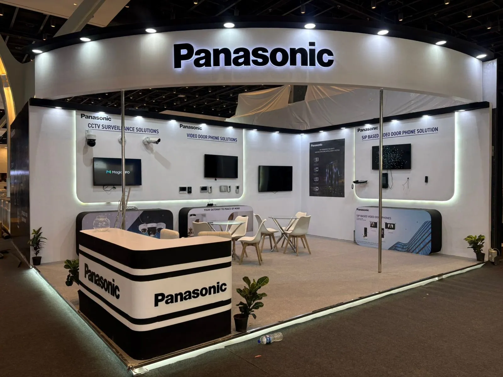 The built Panasonic booth with curved white header and counter