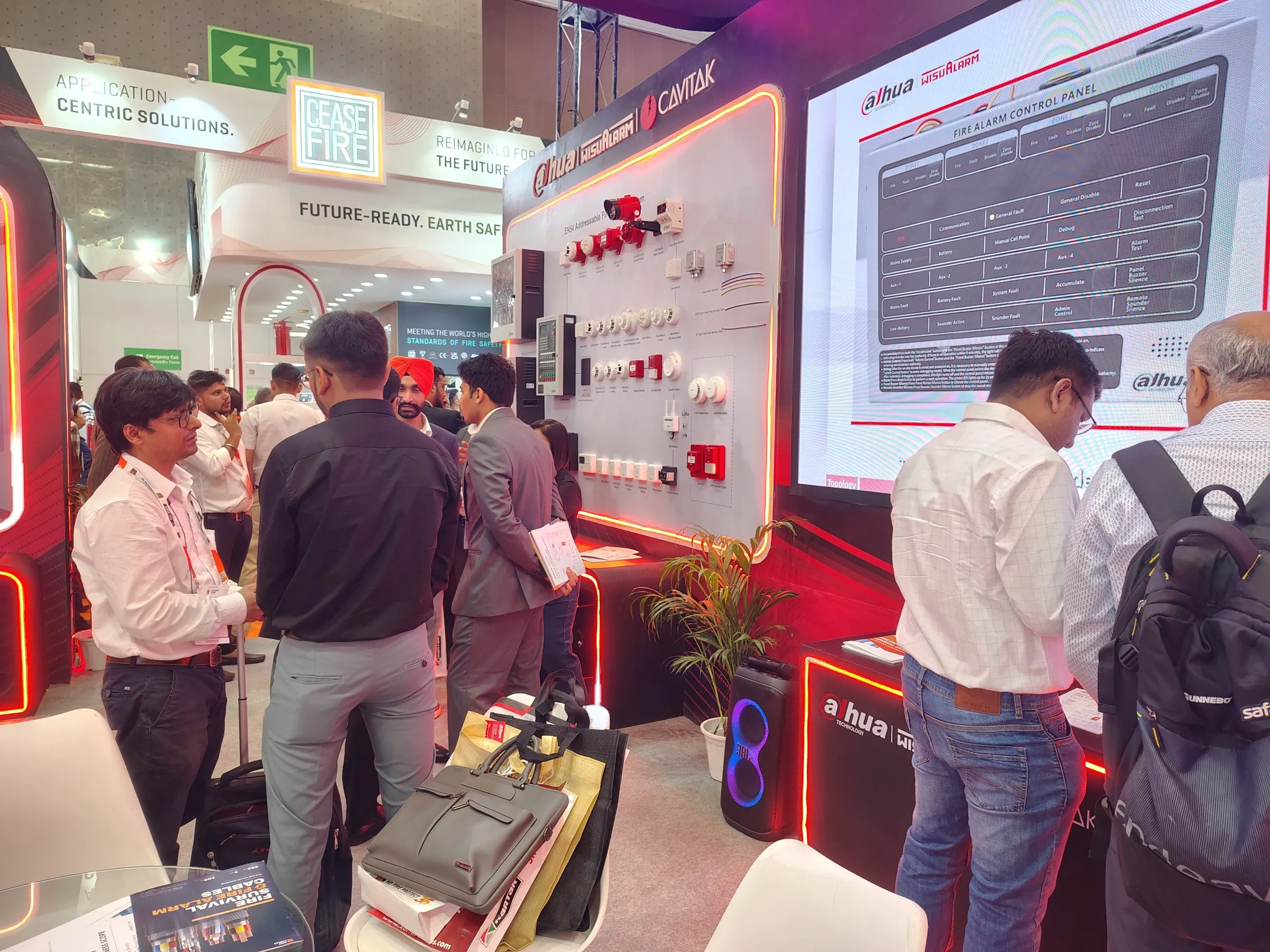 Visitors at the product wall beside the large LED screen