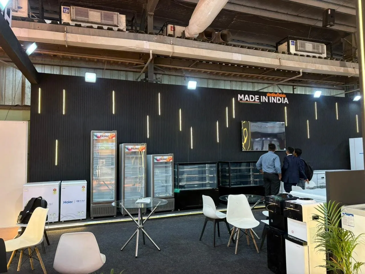 Made in India wall with glass-door freezers and meeting chairs